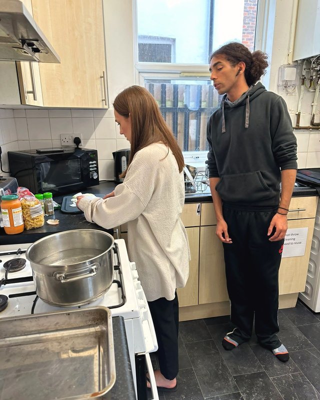 A resident learning to cook with support